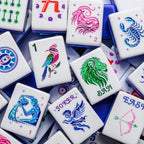Close-up of Lunara mahjong tiles: songbird One Bam, lion Bam Dragon, cherub Joker and zodiac Flowers