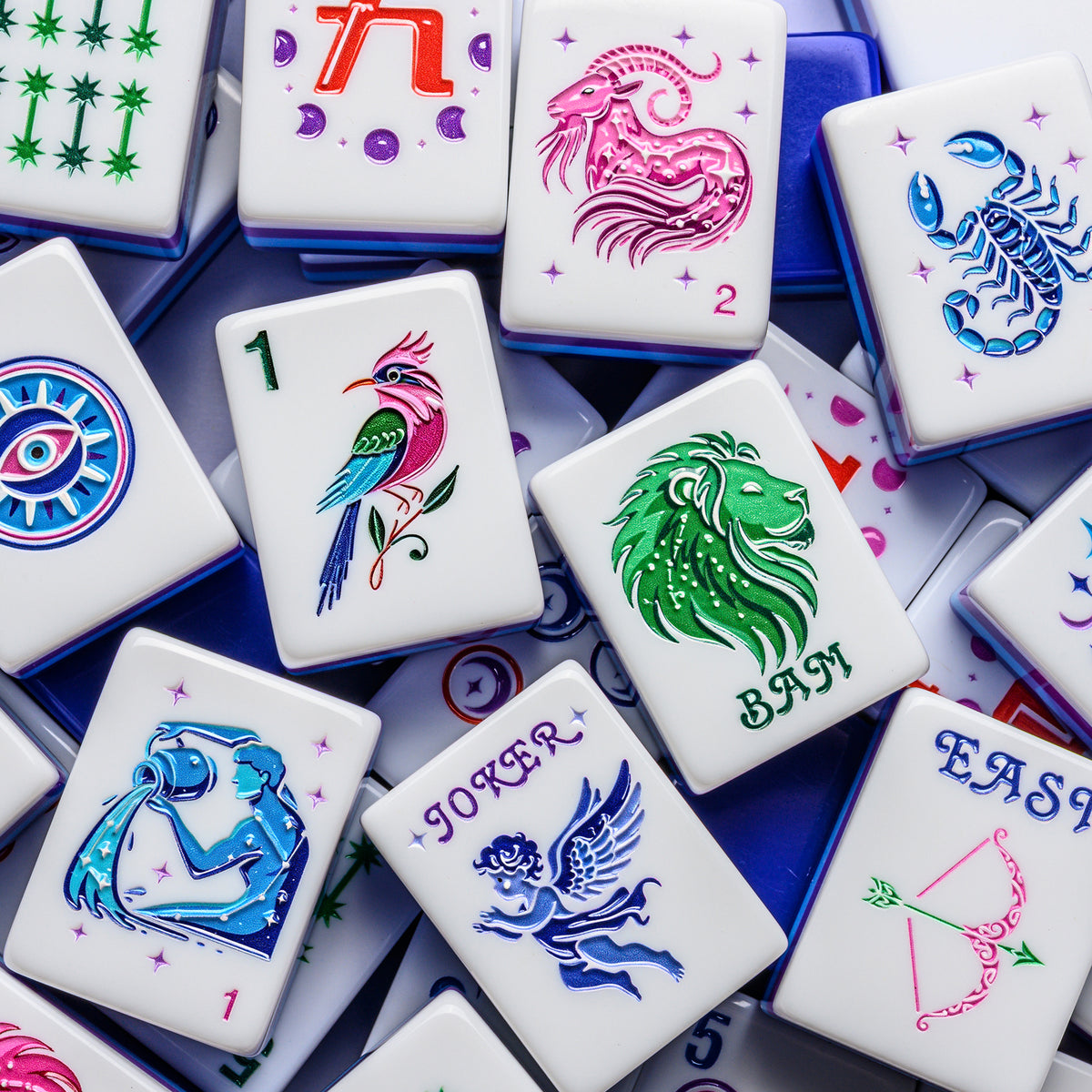 Close-up of Lunara mahjong tiles: songbird One Bam, lion Bam Dragon, cherub Joker and zodiac Flowers