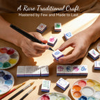 Lunara tiles being color-finished by hand, with paint palettes and brushes
